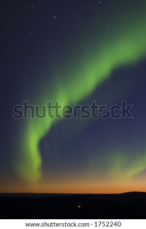 Aurora Borealis (northern lights) over twilight horizon