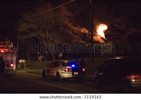 emergency vehicles and people at house fire