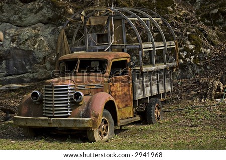 rusting dilapidated truck seen from the drivers side front view