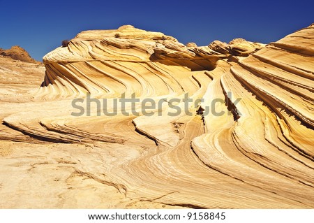 Waves of stone flow up to meet the sky in this beatiful desert background