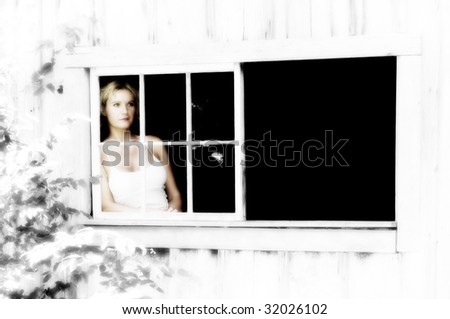 woman gazes out of old broken window with muted colors