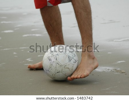 Beach soccer. Feet playing soccer.