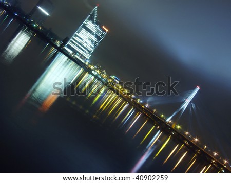 Night shot of the cable bridge and modern building near the center of old town of Riga