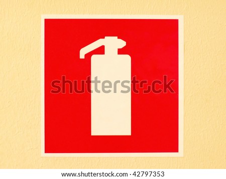 Red fire extinguisher sign/label on the orange wall