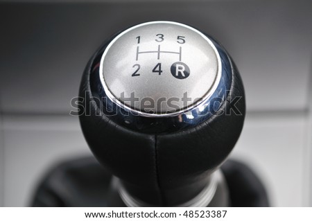 Car\'s shift lever. Macro shot on chrome gear stick. Gearshift.
