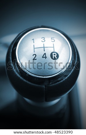 Blue concept of a car\'s shift lever. Macro shot on chrome gear stick. Gearshift.
