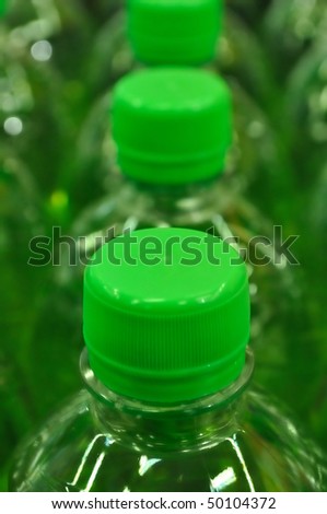 Green plastic bottles of soft drinks.