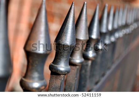 Metal fence with sharp spikes.