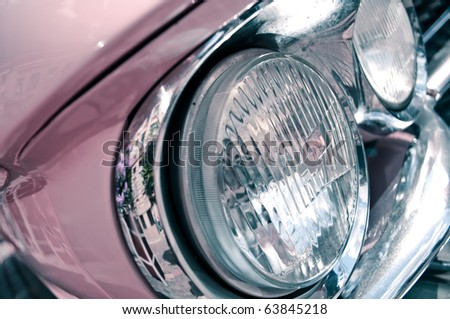 Headlights of the pink retro car.