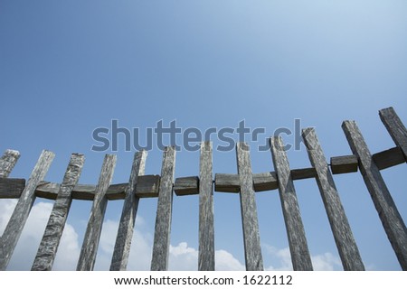 old fence against blue sky