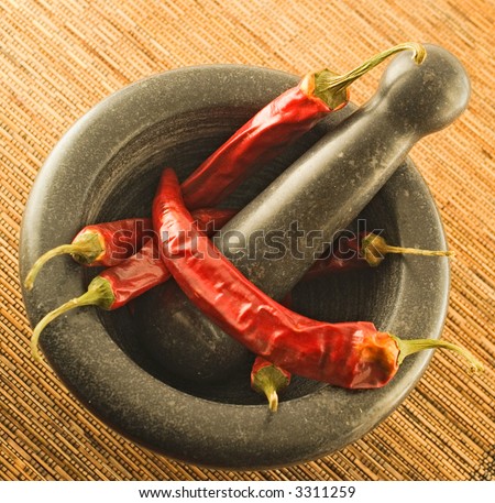 stone mortar with red chillies