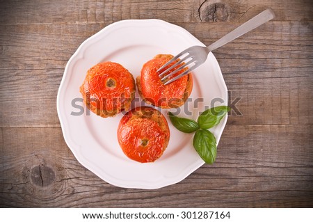 Stuffed tomatoes on glass bowl.