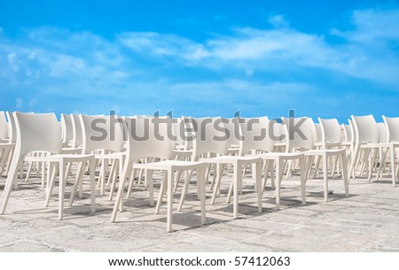 White chair group on blue sky.
