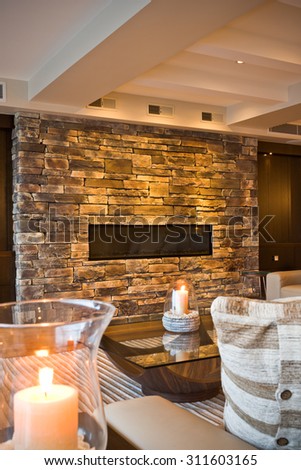 Burning decorative candles in a cozy living room