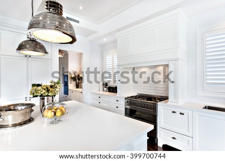 kitchen of luxury and beautiful house with fruit, flower and vessel kept on dinning table