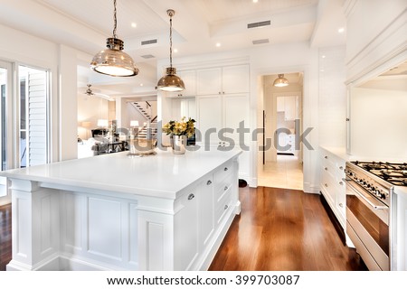 Beautiful kitchen having electrical automatic cooking gas and fruits, flowers kept on table