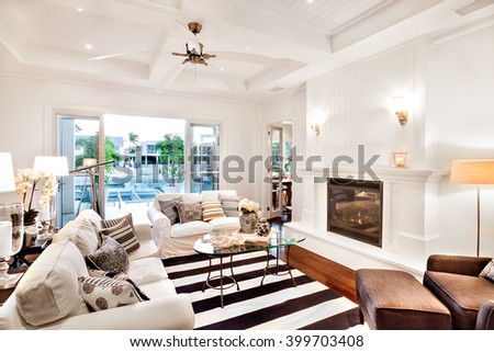 Beautiful sofa set with a glass table in the center and a telescope at the window in a luxury house
