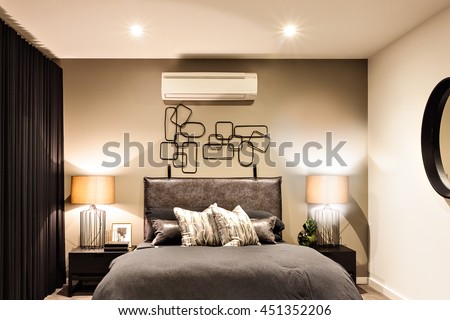 Modern bedroom included flashing table lamps with air conditioner in a luxury house