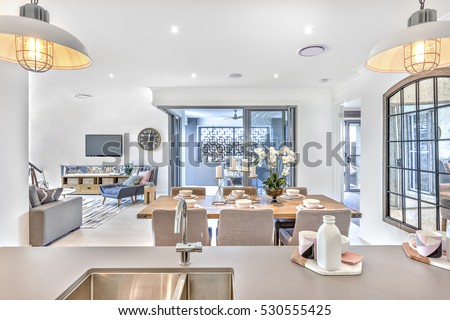 Modern dining room with kitchen counter top and living room in the middle of the house