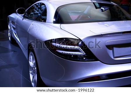 Silver sports car against a dark background. No logo shown.