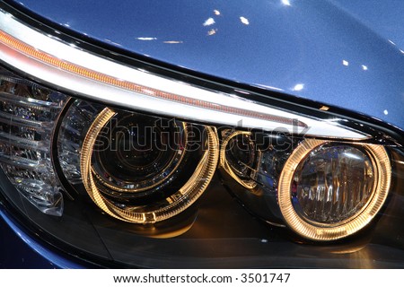 Front headlights of a luxurious sports cars. No logo shown.