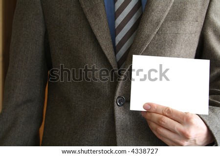 Smartly dressed business man holding a white card (enter your own text).