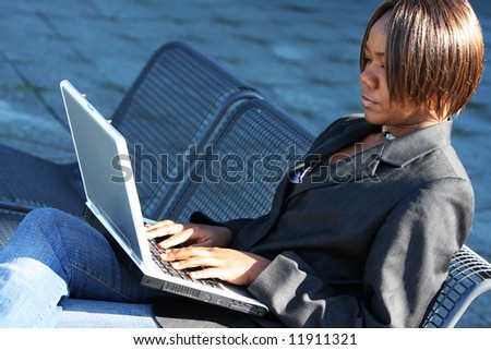 African american woman holding notebook in an office environment.