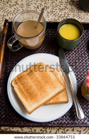 Breakfast meal with toast bread, coffee, orange juice, apples, marmalade