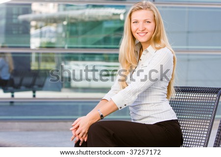 Beautiful attractive blonde business woman looking at you being sweet