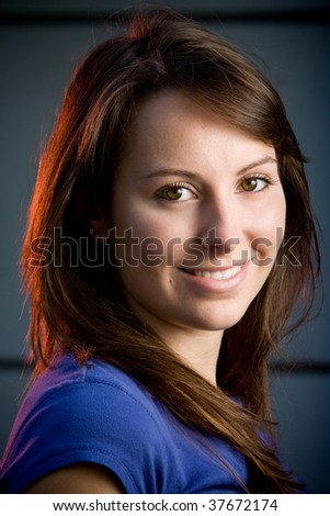 Beautiful brunette teenage model in a night club posing