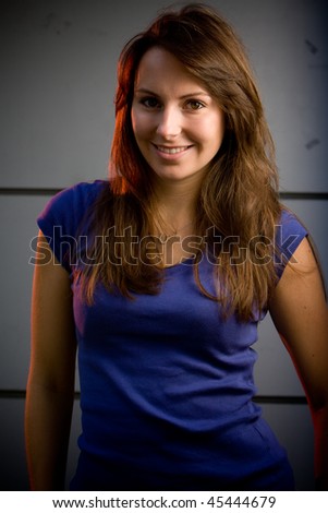 Beautiful brunette teenage model in a night club posing