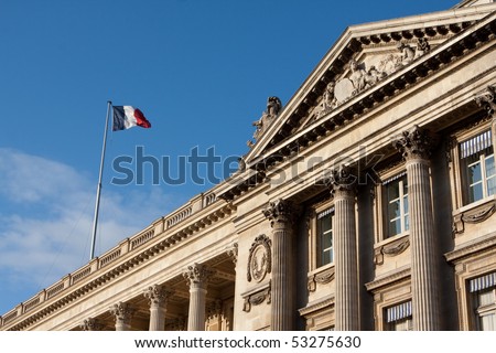 French flag flying in Paris, France on a national historic building along Champs Elysees
