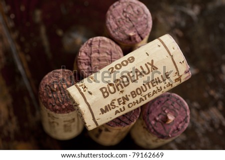 Close up shot of a collection of generic corks from Bordeaux red wine region, focus on one object
