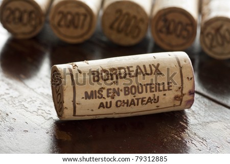 Close up shot of a collection of generic corks from Bordeaux red wine region, focus on one object