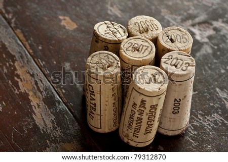 Close up shot of a collection of generic corks from Bordeaux red wine region, focus on the vintage 2003-2009