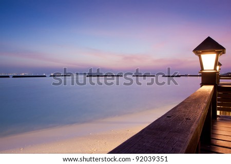 Night sky at a seaside beach resort with sun setting, long exposure