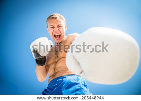Evil guy in boxing gloves trains blow
