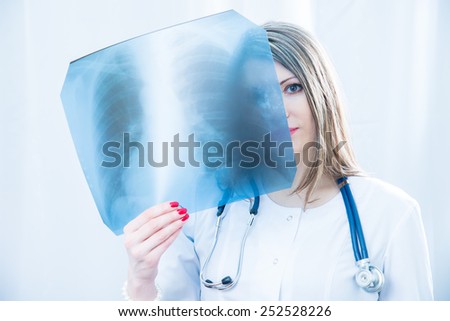 Doctor examining an X-ray light
