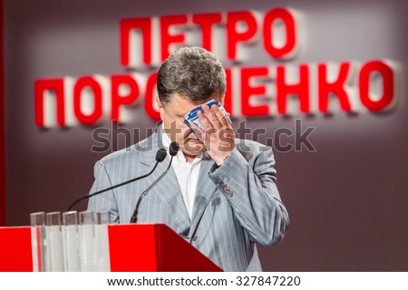 KYIV, UKRAINE - May 27, 2014. The election campaign of the presidential candidate of Ukraine Petro Poroshenko. Petro Poroshenko, hand wipes sweat from his forehead