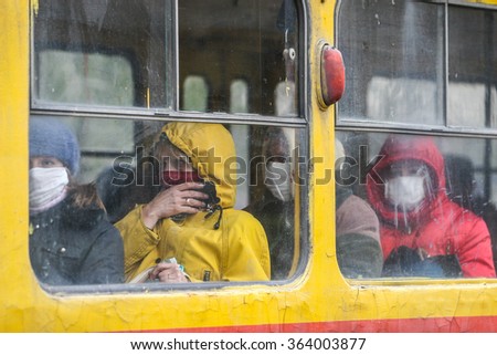 KYIV, UKRAINE - 02.11.2009. Flu epidemic. Passengers travel in transport, covering her face with protective gauze bandages.