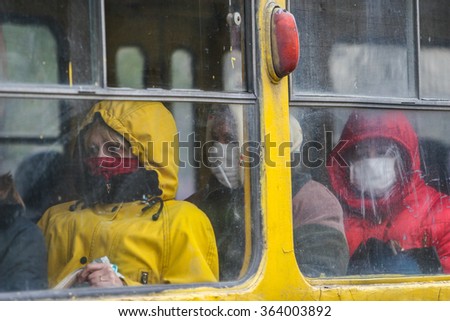 KYIV, UKRAINE - 02.11.2009. Flu epidemic. Passengers travel in transport, covering her face with protective gauze bandages.