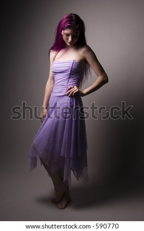 Girl with long purple hair wearing purple dress.