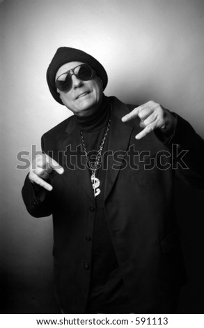 Older man dressed as young gang member.