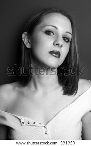 Portrait of a beautiful young girl wearing a white shirt off the shoulder.