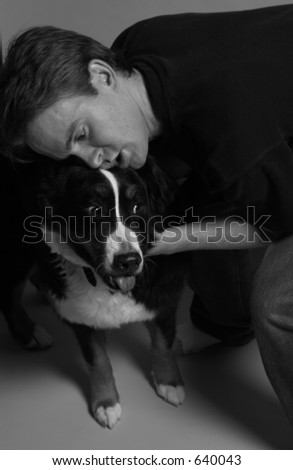 man hugging dog