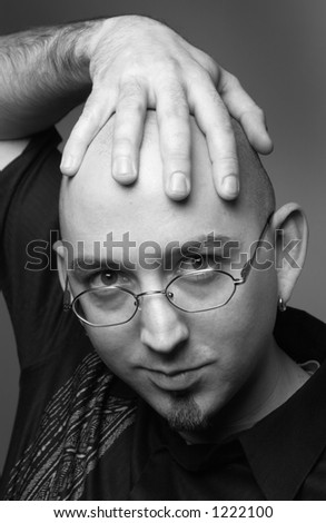 bald man with hand on head
