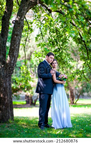 bride and groom outdoors park under trees