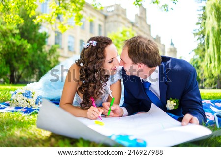 Happy man and woman colouring or drawing hearts at the garden. Love concept