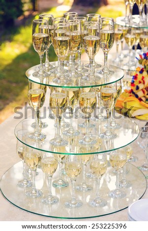 pyramid of champagne glasses during catering at party.