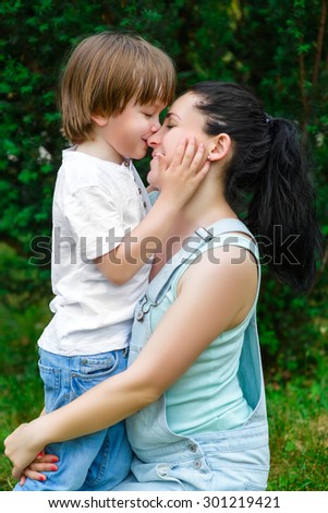 Loving son kissing his happy mother on the nose